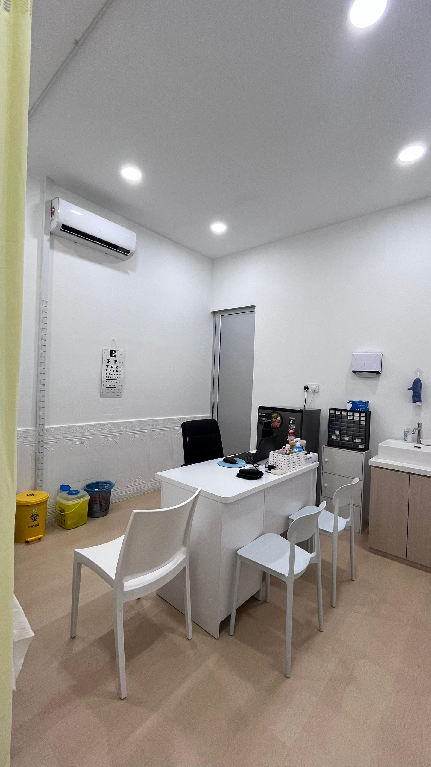 Consultation room with doctor's desk at OneHealth Clinic Pontian