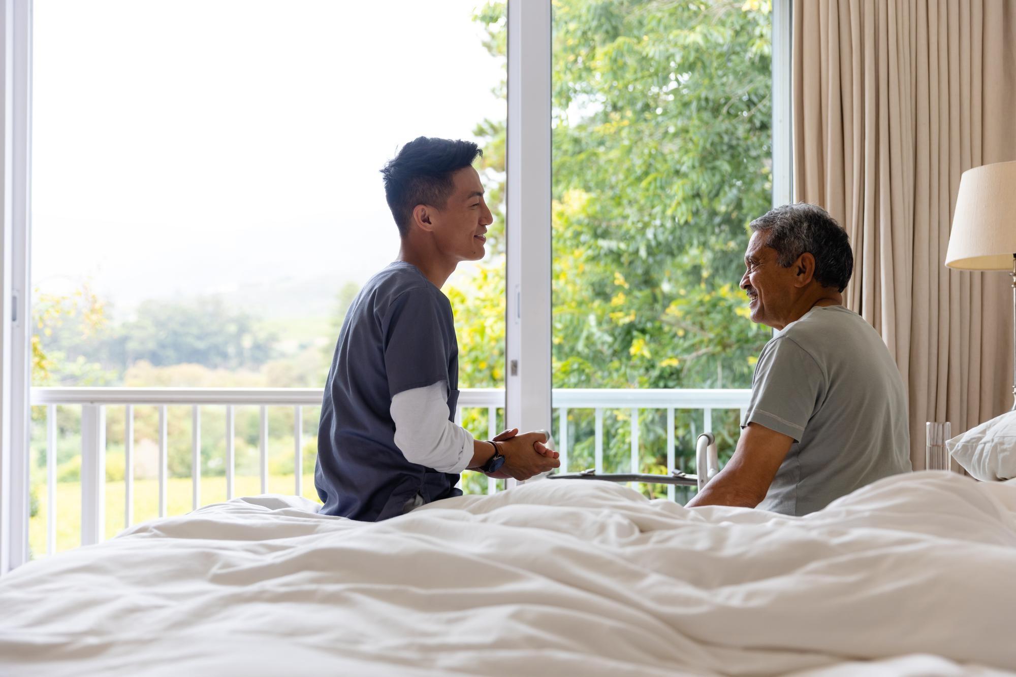 A OneHealth Clinic caregiver visiting an elderly patient at home during a house call in Johor Bahru
